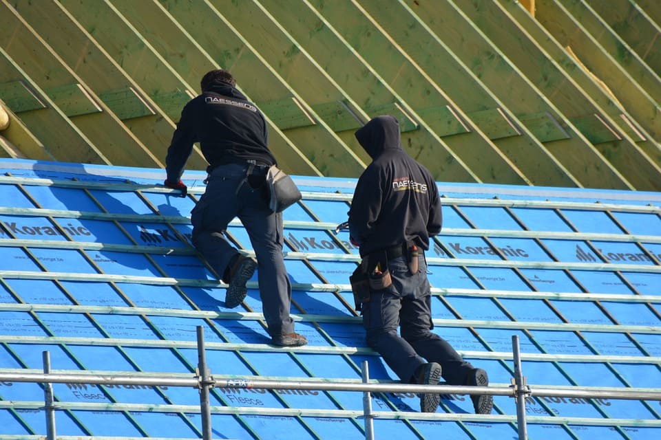man fixing roof